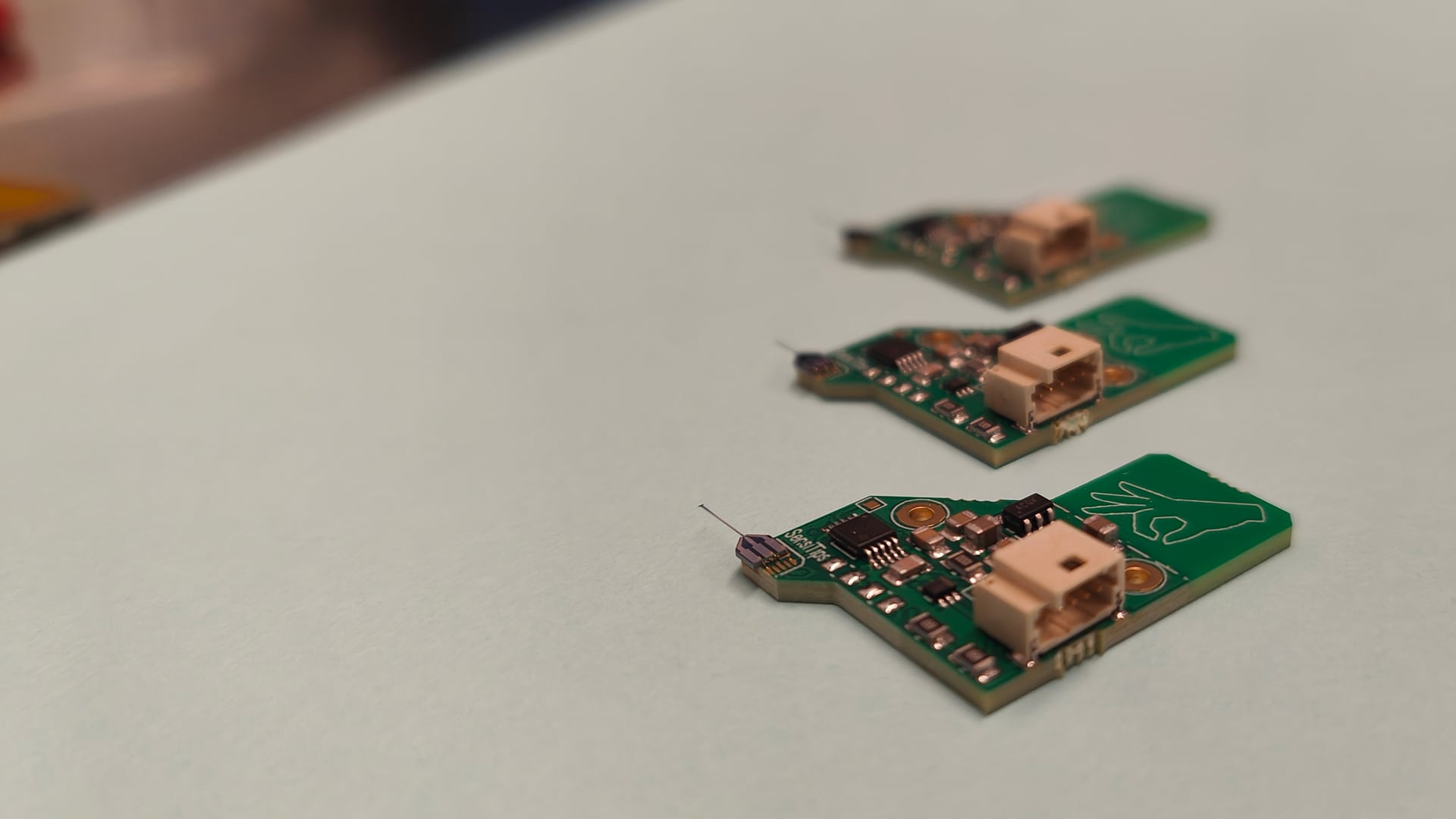 Three SensiTips microforce sensors on a workbench